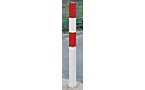 Barrier post with base plate to bolt in place