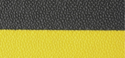 Egy fekete-sárga ipari szőnyeg struktúrája