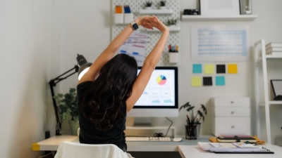 Office worker relaxes at her office desk