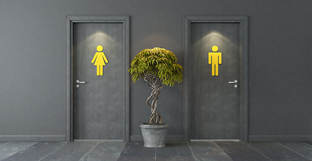 Two toilet doors. One with a male sign, the other with a female sign.