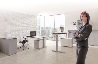 A woman standing in an office with mauser furniture