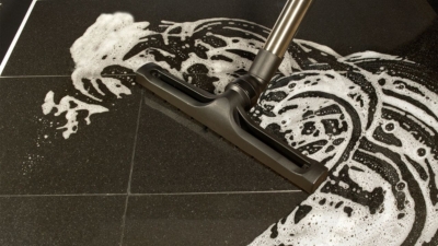 Wet and dry vacuum cleaner in use on a soapy floor