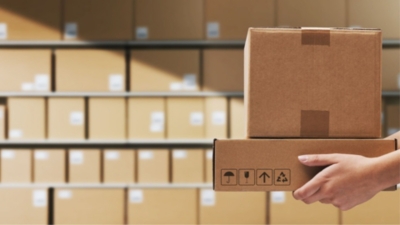 Parcel delivery collection from a stack of cardboard boxes