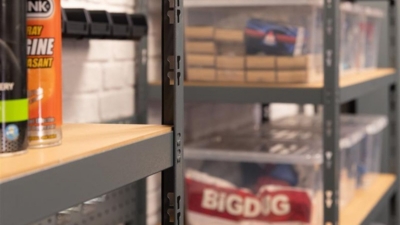 Home garage shelving units holding boxes and automotive equipment