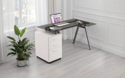A glass computer desk in a home on a wooden floor