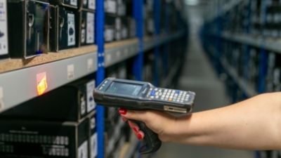 Warehouse picker uses a barcode scanner to update inventory