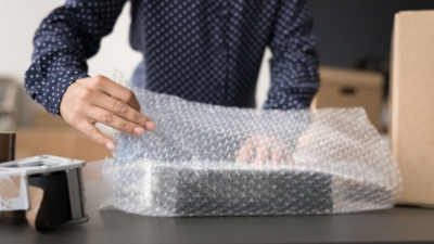 Wrapping a package in bubble wrap ready for delivery