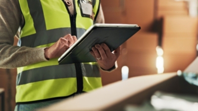 Inspector carrying out a professional flood risk assessment in a warehouse